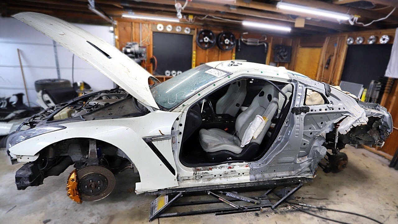 A car stripped back to bare panels in the workshop