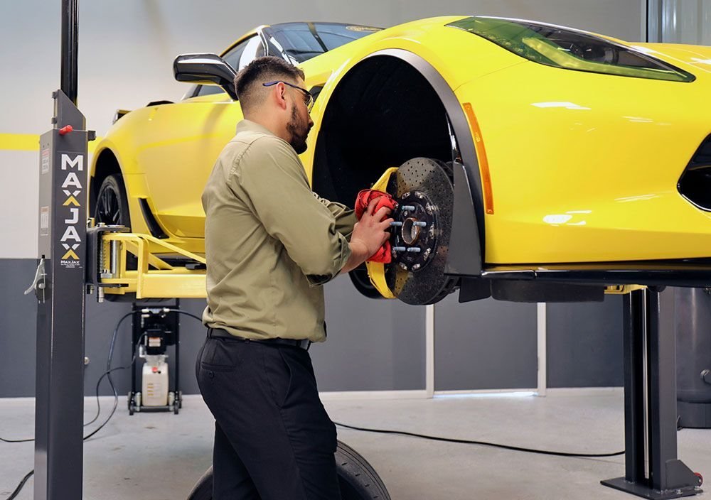 A supercar raised on the lift for body and wheel work