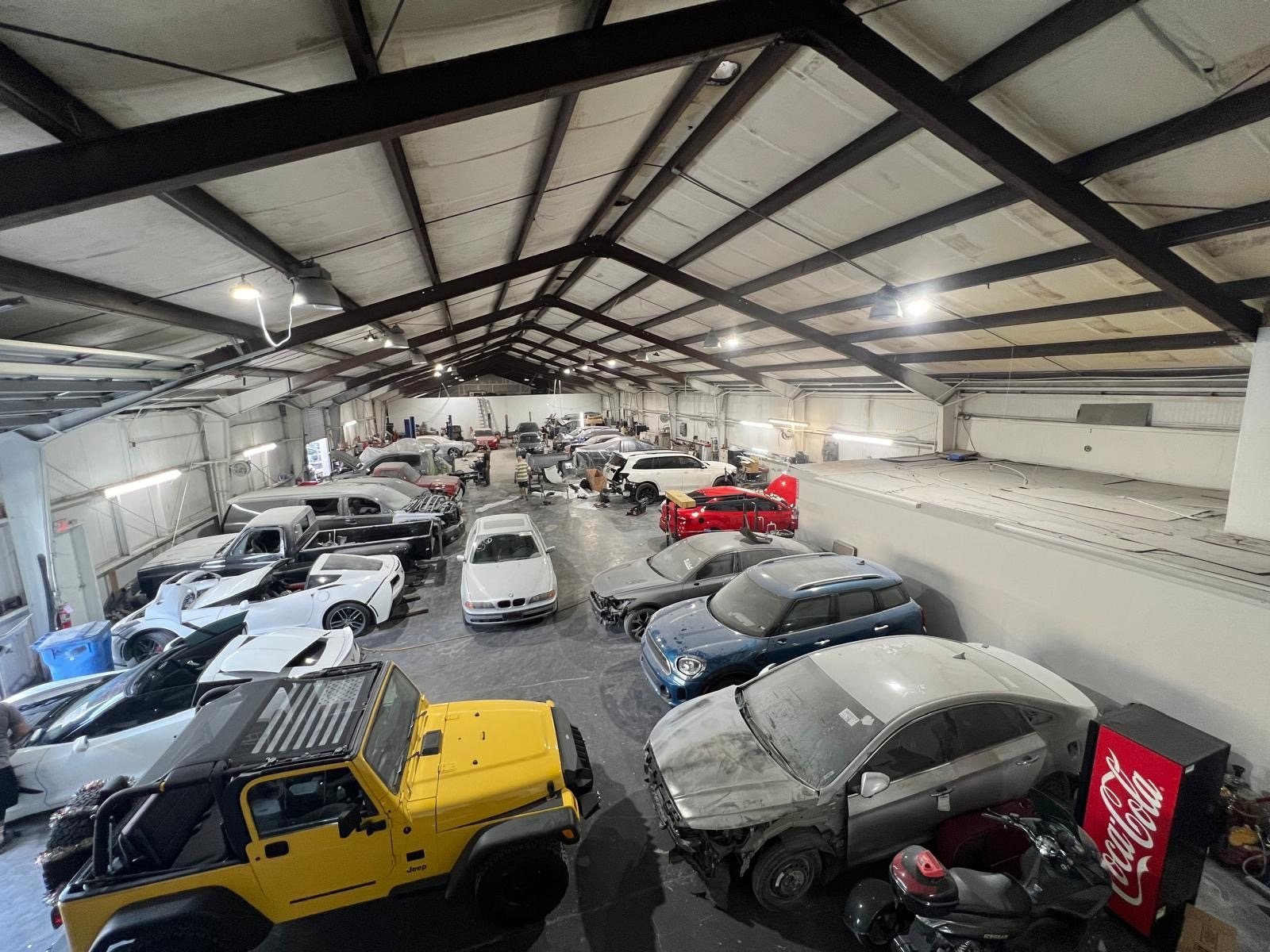 Customer vehicles parked across the Tampa Body Shop lot