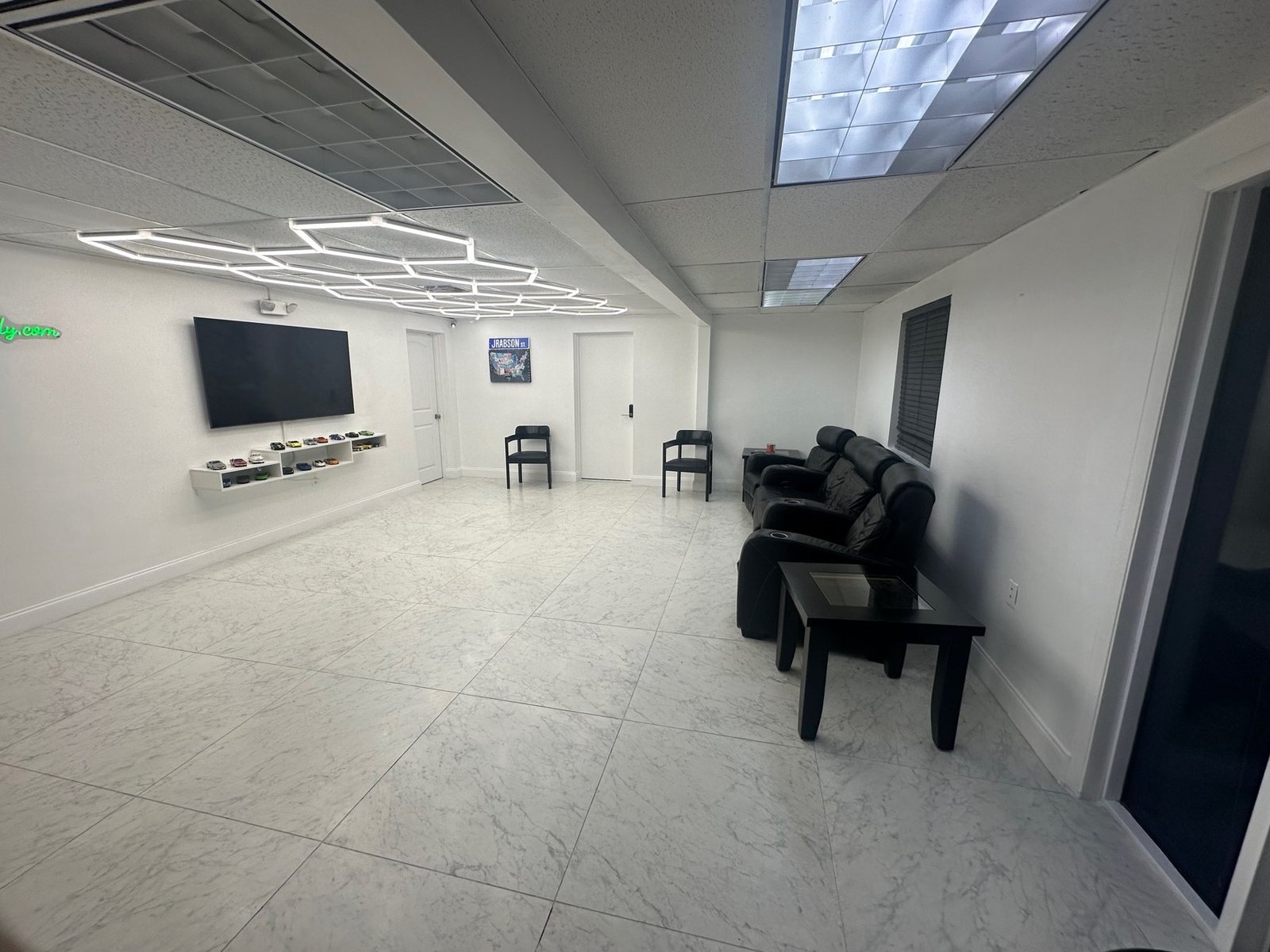 Clean, quiet waiting room with seating and TV